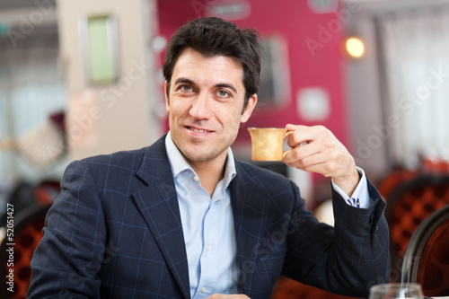 Photo: Man having a coffee at the restaurant Man having a coffee at the restaurant