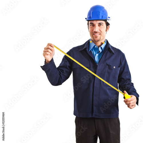 Photo: Portrait of an engineer using a measuring tape Portrait of an engineer using a measuring tape