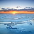Photo: colorful sunset at the snowy Baltic sea shore colorful sunset at the snowy Baltic sea shore