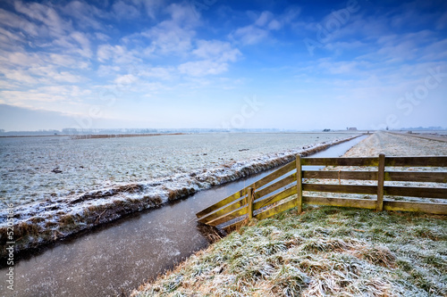 Photo: wooden fence in Dutch farmland wooden fence in Dutch farmland