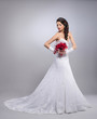 Photo: Young and beautiful bride standing with the flower bouquet Young and beautiful bride standing with the flower bouquet