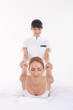 Photo: Young woman getting traditional thai stretching masage Young woman getting traditional thai stretching masage