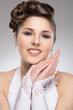 Photo: Young and beautiful bride over the grey background Young and beautiful bride over the grey background