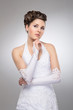 Young and beautiful bride over the grey background