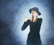 Photo: Young attractive killer widow over grey background Young attractive killer widow over grey background