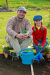 Gardening, planting - girl helping father in the garden