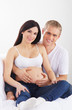 Young attractive couple: pregnant mother and happy father