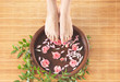 Spa background with a beautiful legs, flowers and petals
