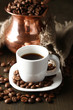 Cup of coffee and pot on wooden background