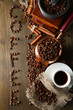 Cup of coffee, pot and grinder on wooden background