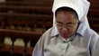 People and religion, nun praying in church during mass
