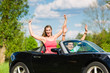 Foto: Young couple with cabriolet in summer on day trip Young couple with cabriolet in summer on day trip