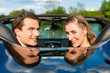 Foto: Young couple with cabriolet in summer on day trip Young couple with cabriolet in summer on day trip