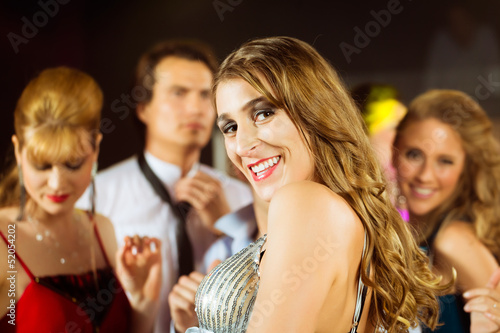 Photo: party people dancing in disco club party people dancing in disco club