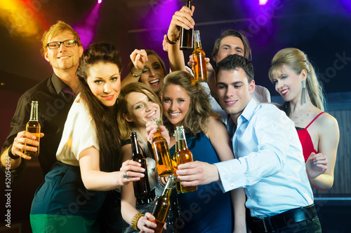 Photo: People in club or bar drinking beer People in club or bar drinking beer