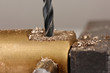 Drilling hole into metal, on color background