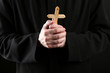 Priest holding cross, close up