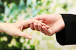 Priest holding woman hand, on green background
