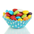 Colorful candies in cupcake case isolated on white