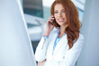 A beautiful young real estate agent woman on the phone