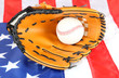 Baseball glove and ball on American flag background