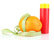 Orange with measuring tape and body cream, isolated on white