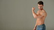 Handsome Muscular Man in Jeans Showing His Muscles