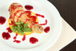 Small portion of food on big plate on wooden table