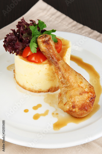 Photo: Small portion of food on big plate on wooden table Small portion of food on big plate on wooden table