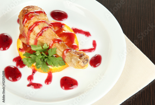 Photo: Small portion of food on big plate on wooden table Small portion of food on big plate on wooden table