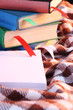 Many books with bookmarks on plaid close-up