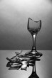 Broken wineglass on grey background