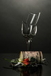 Broken wineglass and money on grey background