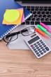 Laptop with stationery on table