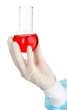 Glass tube with fluid in scientist hand during medical test