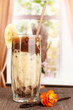 Delicious fruit smoothie on window background
