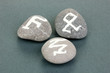 Fortune telling  with symbols on stones on grey background