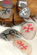 Fortune telling  with symbols on stones on white fur background