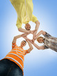Three smiling friends staying together isolated on blue