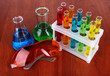 Test tubes with colorful liquids on wooden background
