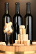 Wine and corks on barrel on brown background