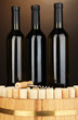 Wine and corks on barrel on brown background