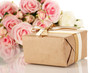 Beautiful gift on flowers background isolated on white
