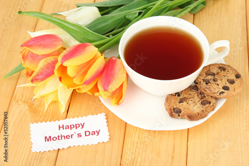 Photo: Composition of tulips and cup with some drink, Composition of tulips and cup with some drink,