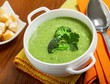 Broccoli cream soup and crusts on a table