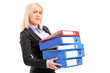 Photo: A young professional woman holding folders A young professional woman holding folders
