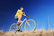 A young male riding a mountain bike