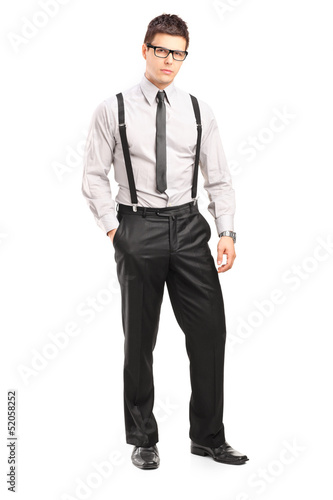 Photo: Full length portrait of a young stylish man looking at camera Full length portrait of a young stylish man looking at camera
