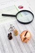 Photo: Business concept with magnifier and chess pieces on colorful bac Business concept with magnifier and chess pieces on colorful bac