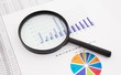 Magnifier on business background. Use for company strategic beha